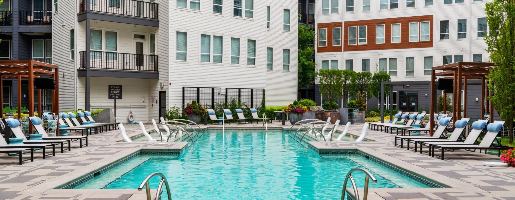 a pool in a courtyard between buildings