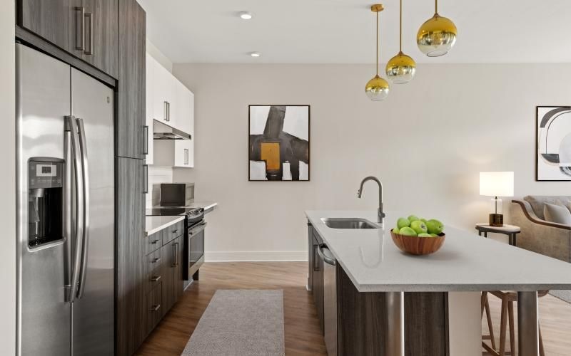 a kitchen with an island and a refrigerator