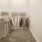 a walk-in closet with clothes hanging