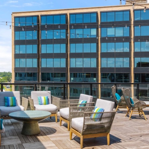 Everything within reach a patio with chairs and tables outside a building